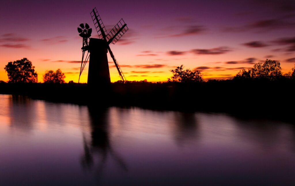 Riverside properties in Norfolk, Windmill at sunset on the Norfolk Broads